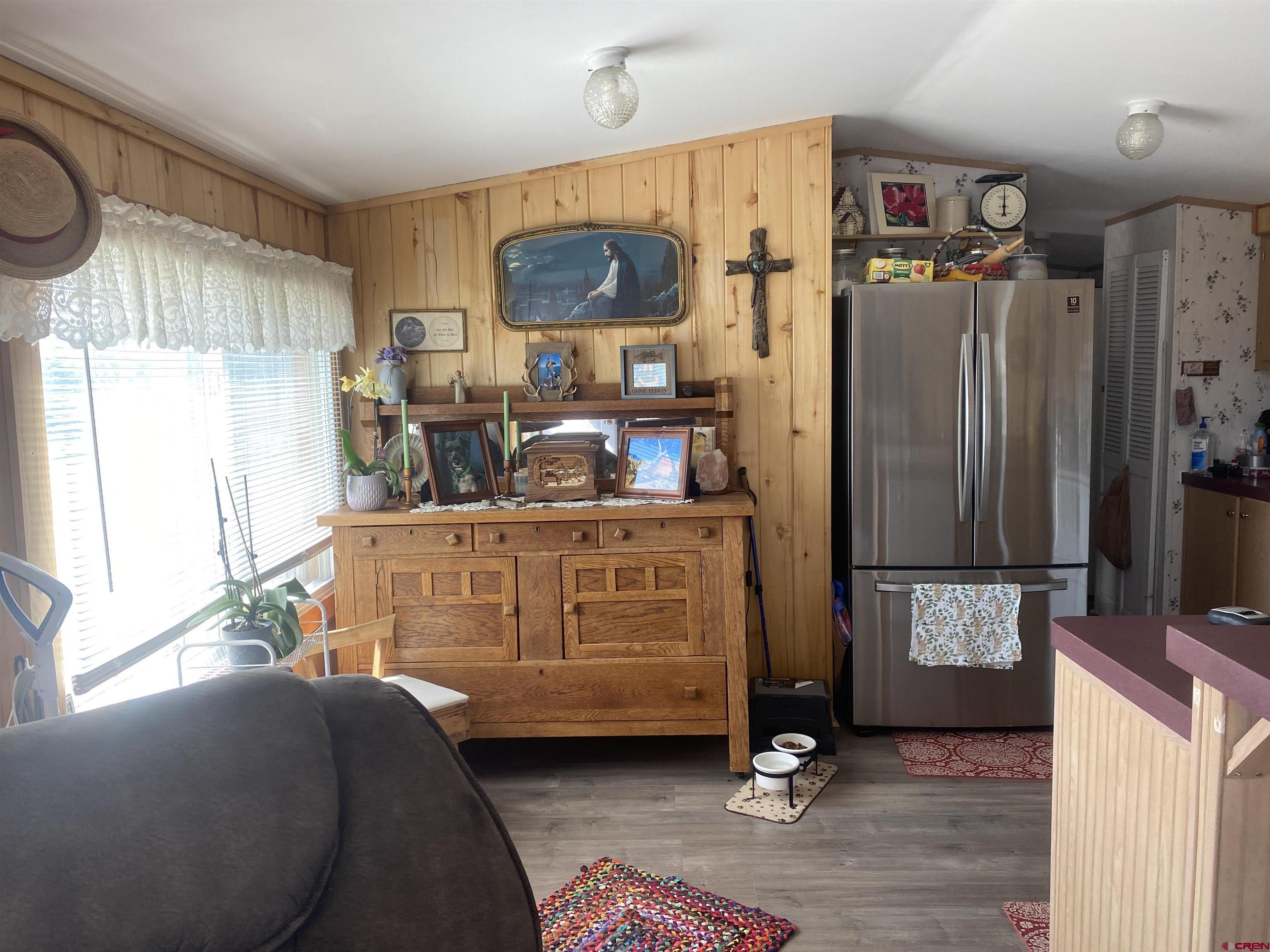 16937 2550th Road Cedaredge, CO 81413 - Photo 4 of 8 a living room with a bed furniture and a window