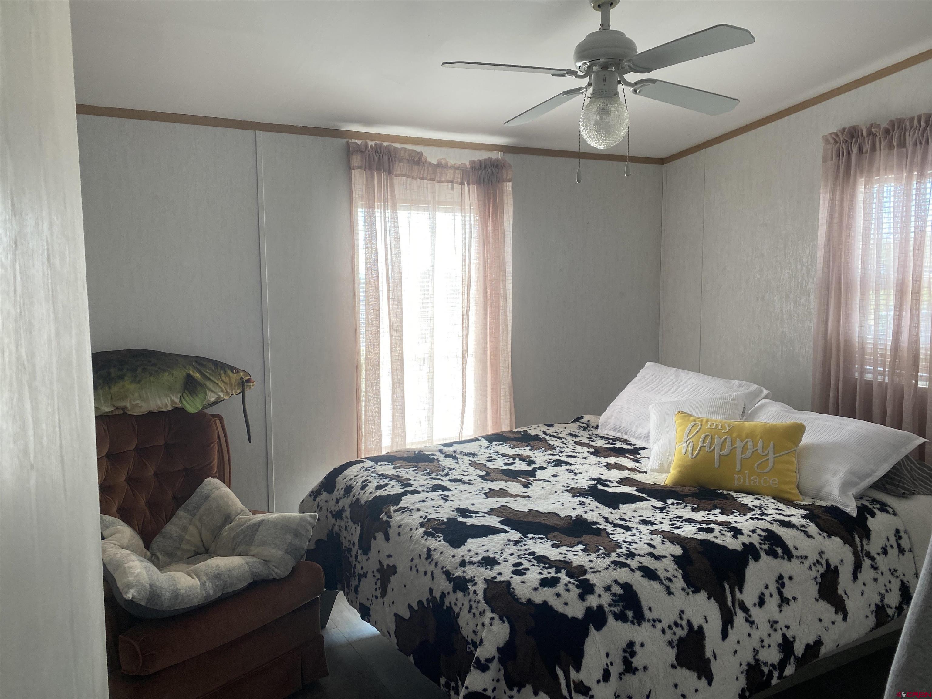 16937 2550th Road Cedaredge, CO 81413 - Photo 5 of 8 a bedroom with a bed and window