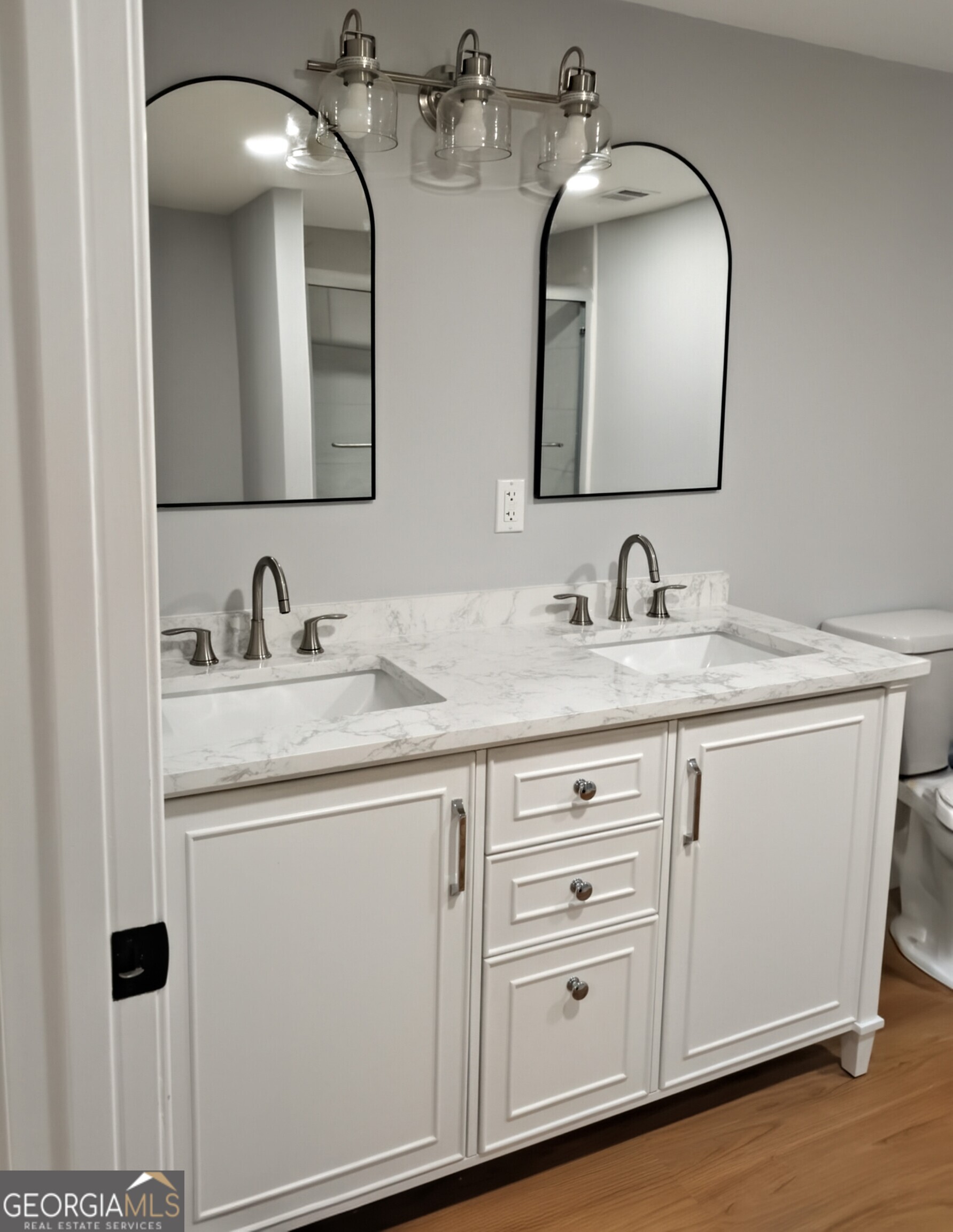 481 West Currahee Street Toccoa, GA 30577 - Photo 15 of 26 a bathroom with a double vanity sink and a mirror