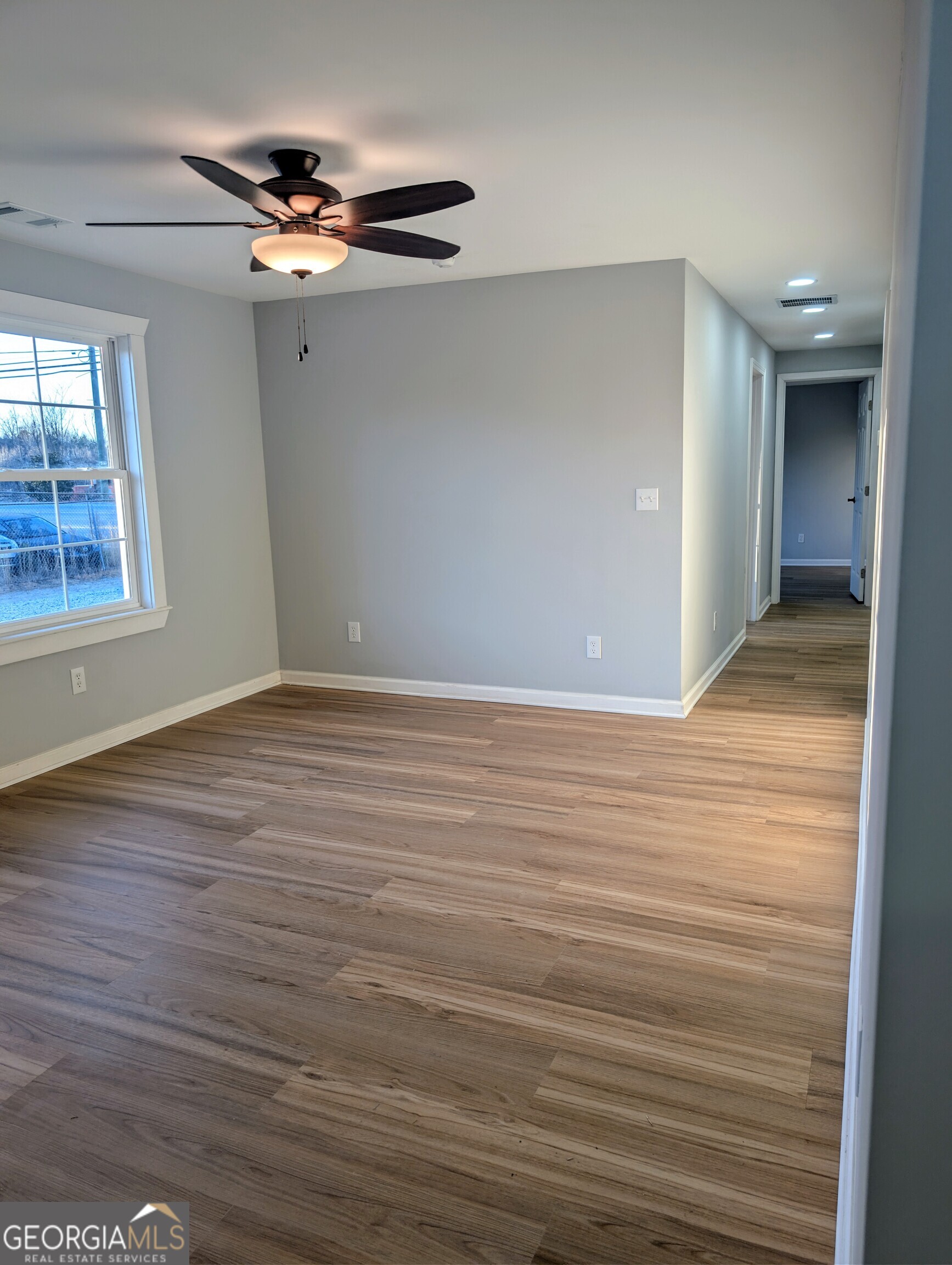481 West Currahee Street Toccoa, GA 30577 - Photo 5 of 26 an empty room with wooden floor and windows