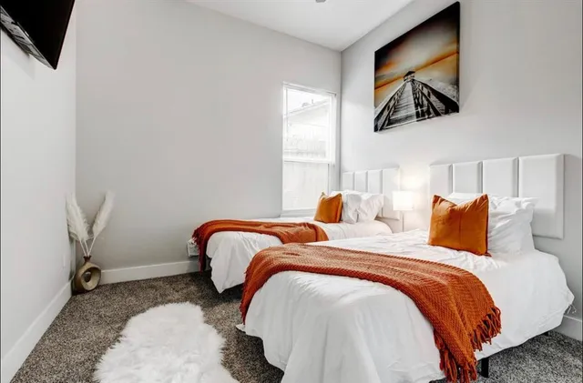 a bedroom with bed and window