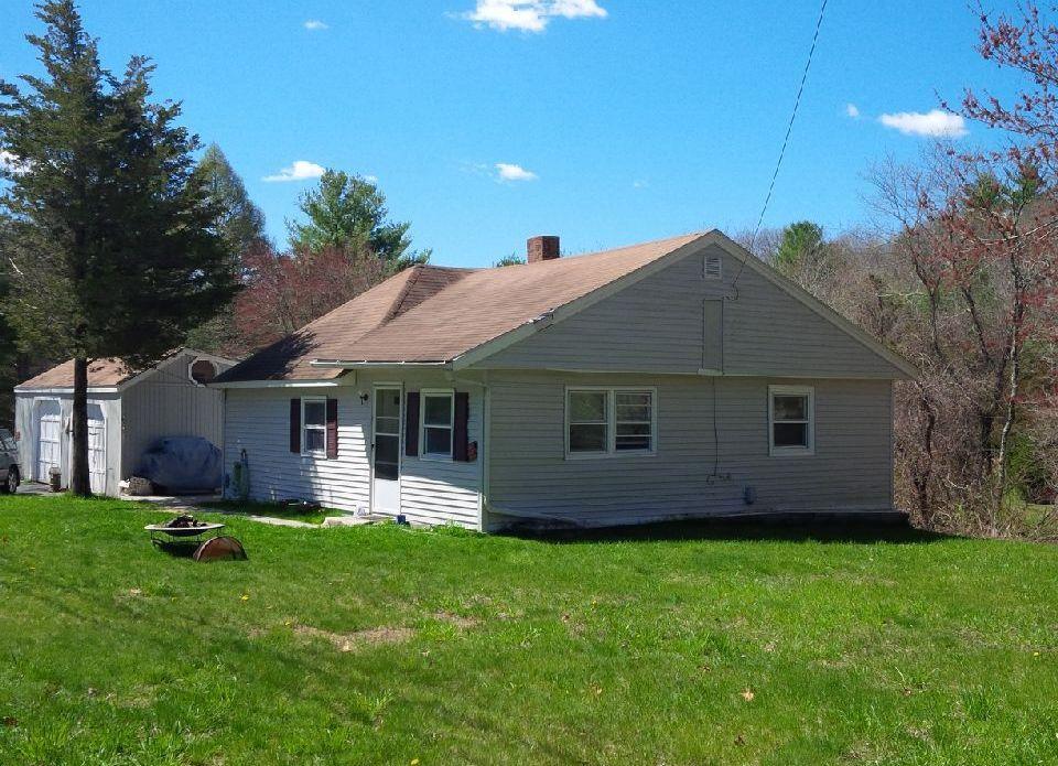 a front view of house with a garden