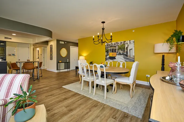 a dining room with furniture and wooden floor