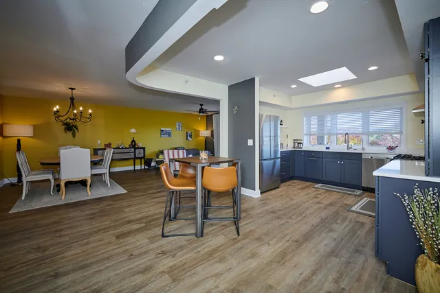 a living room with dining room and wooden furniture