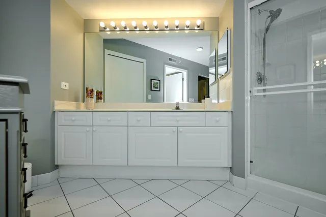 a bathroom with a sink a vanity and a mirror