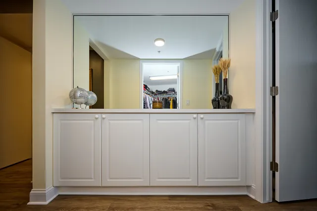 a view of cabinets with a sink and mirror