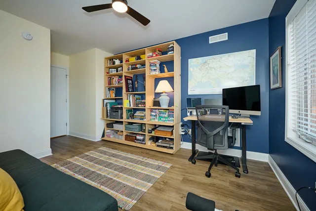 a living room with furniture a flat screen tv and a window