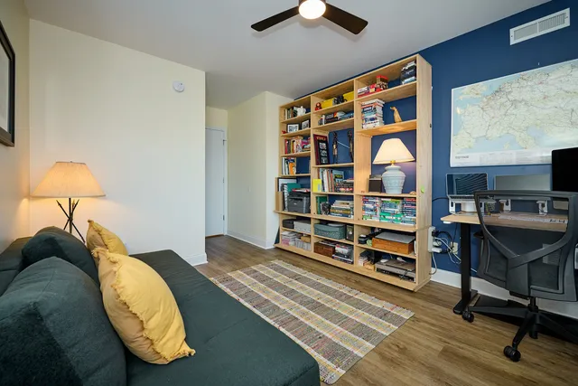 a bed sitting in a bedroom next to a window