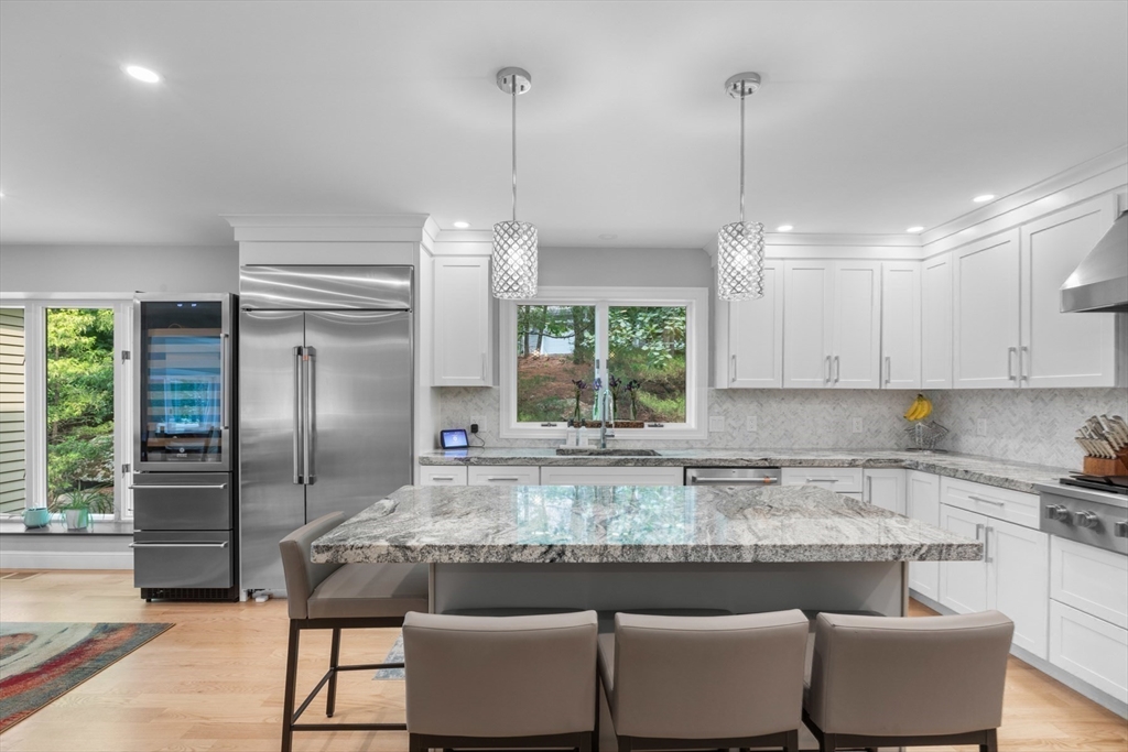 4 The Fairways Ipswich, MA 01938 - Photo 11 of 40 a kitchen with stainless steel appliances granite countertop a refrigerator a stove and white cabinets with wooden floor