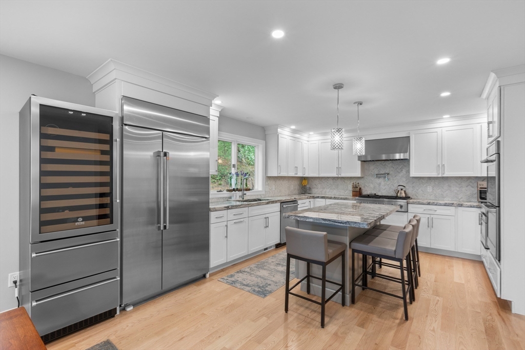 4 The Fairways Ipswich, MA 01938 - Photo 12 of 40 a kitchen with kitchen island white cabinets and stainless steel appliances