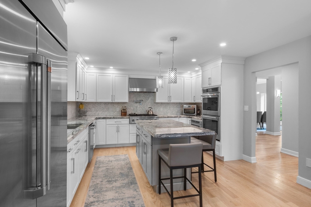 4 The Fairways Ipswich, MA 01938 - Photo 14 of 40 a kitchen with kitchen island granite countertop lots of counter top space and refrigerator