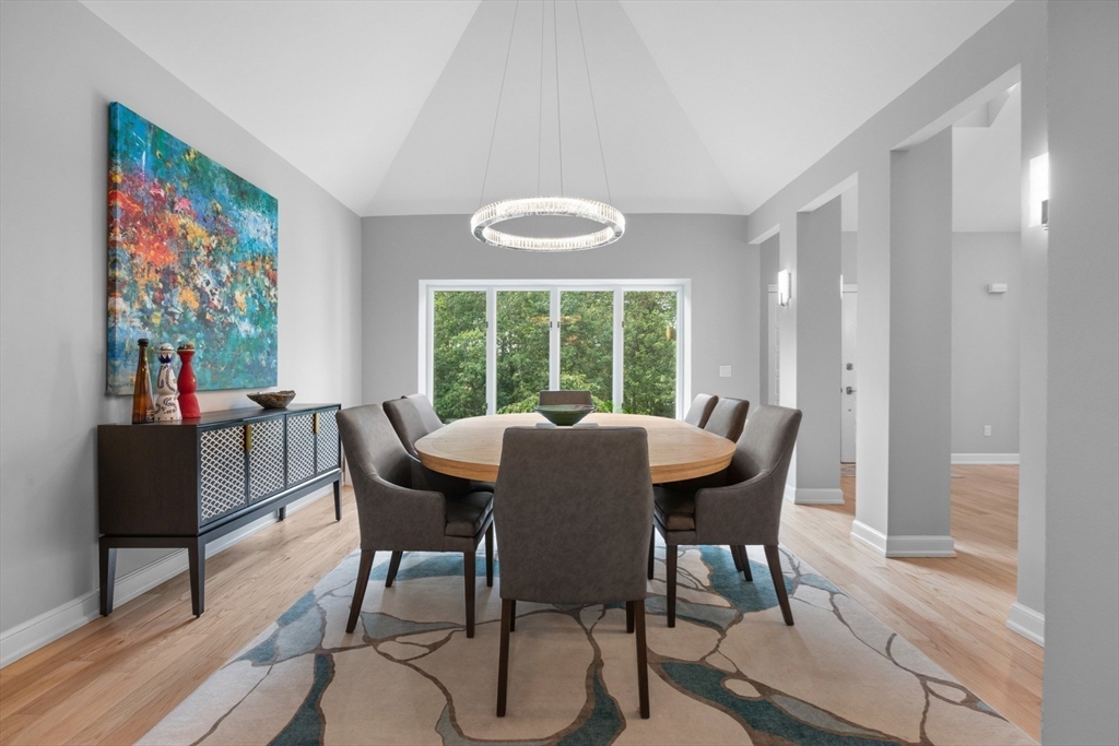 4 The Fairways Ipswich, MA 01938 - Photo 20 of 40 a view of a dining room with furniture a chandelier and wooden floor