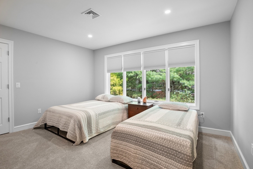 4 The Fairways Ipswich, MA 01938 - Photo 32 of 40 a spacious bedroom with two bed and a large window