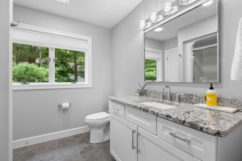 4 The Fairways Ipswich, MA 01938 - Photo 34 of 40 a bathroom with a granite countertop sink a toilet and a window