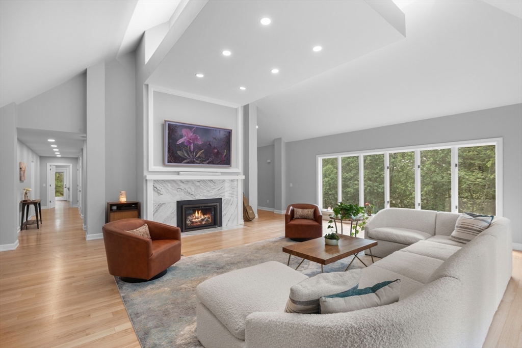 4 The Fairways Ipswich, MA 01938 - Photo 7 of 40 a living room with furniture a fireplace and a large window