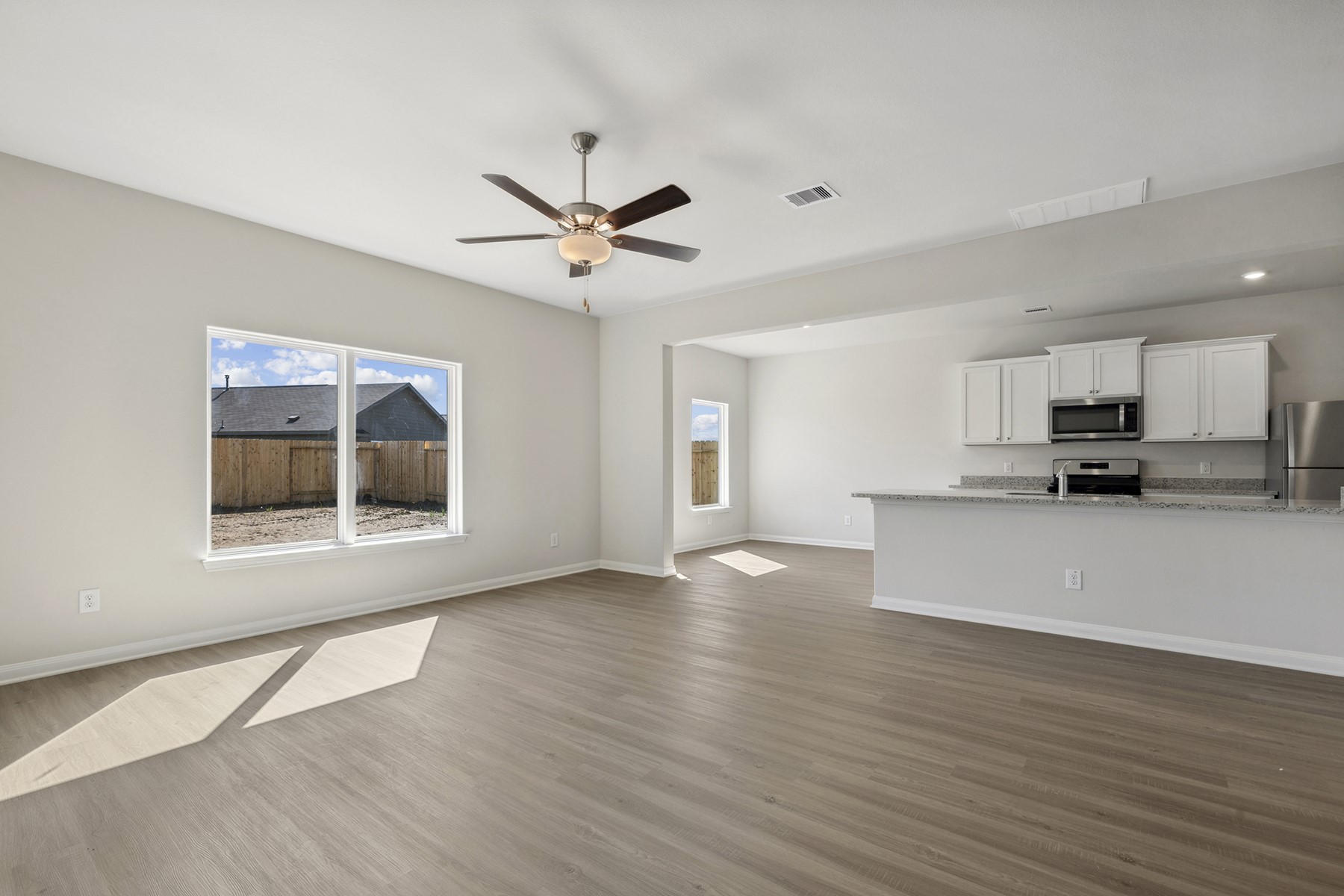 324 Fastboy Lane Waller, TX 77484 - Photo 3 of 13 a view of an empty room with a window and wooden floor