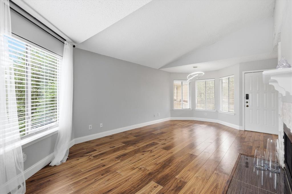 5550 Spring Valley Road, Unit A31 Dallas, TX 75254 - Photo 3 of 24 Spacious interior with vaulted ceilings and wood-finish flooring