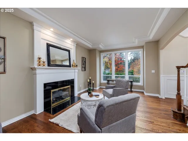 a living room with furniture a large window and a fireplace