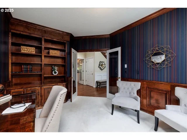 a living room with furniture and a bookshelf
