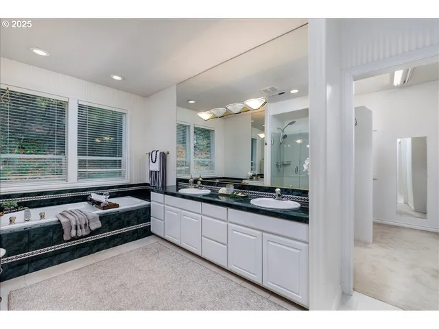 a large white kitchen with a large window