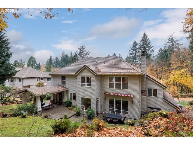 a view of a house with yard and sitting area