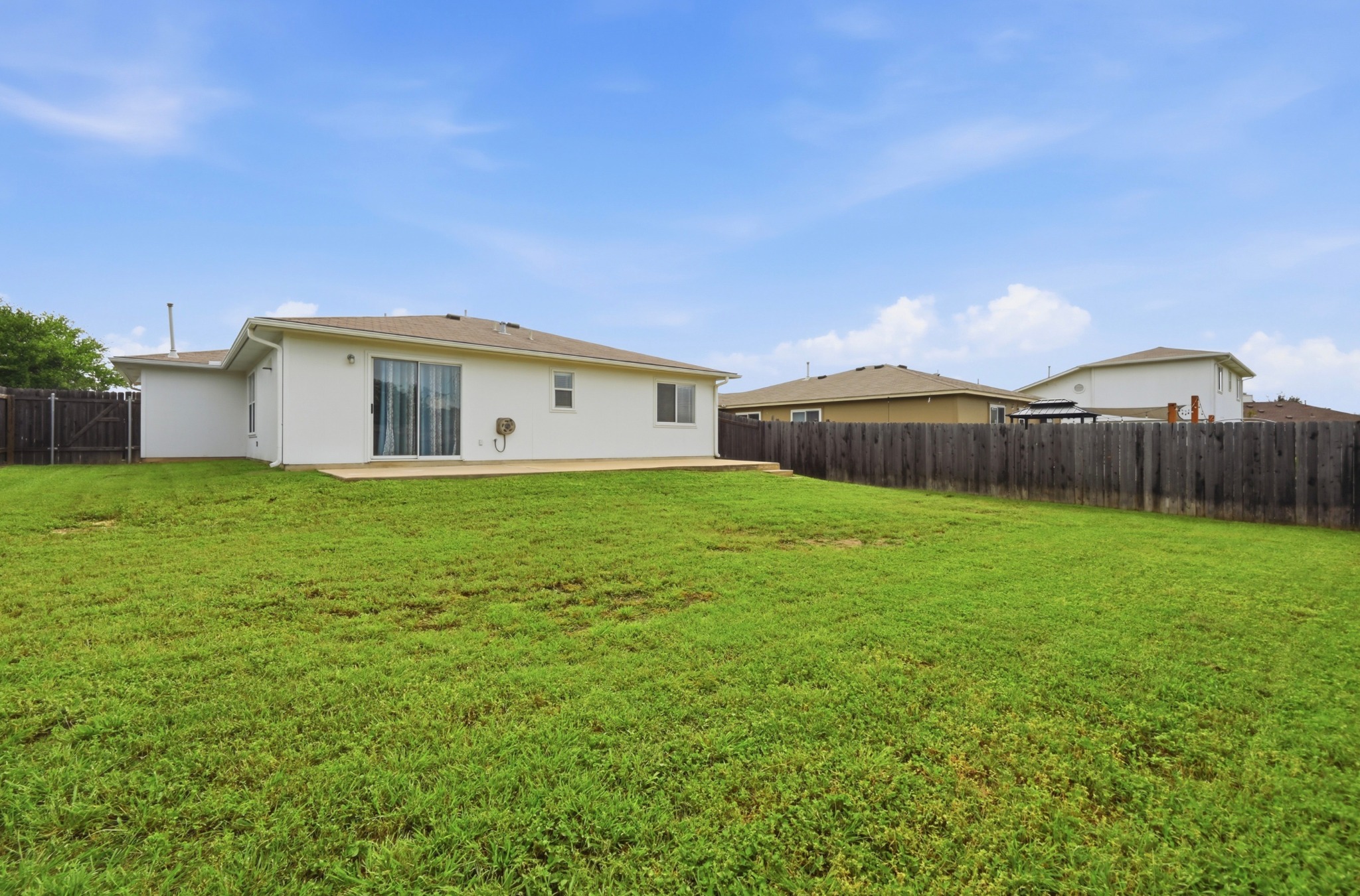 112 Mason Reed Cove Kyle, TX 78640 - Photo 25 of 26 a view of a house with a yard and a large tree