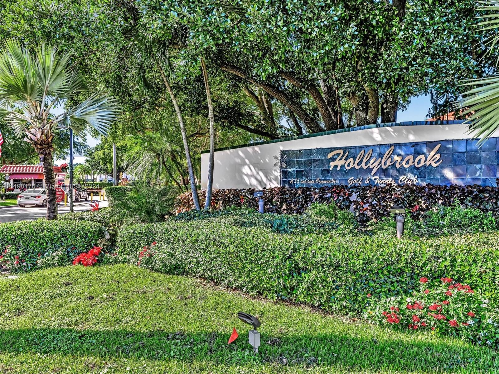 a sign that is sitting in front of flowers