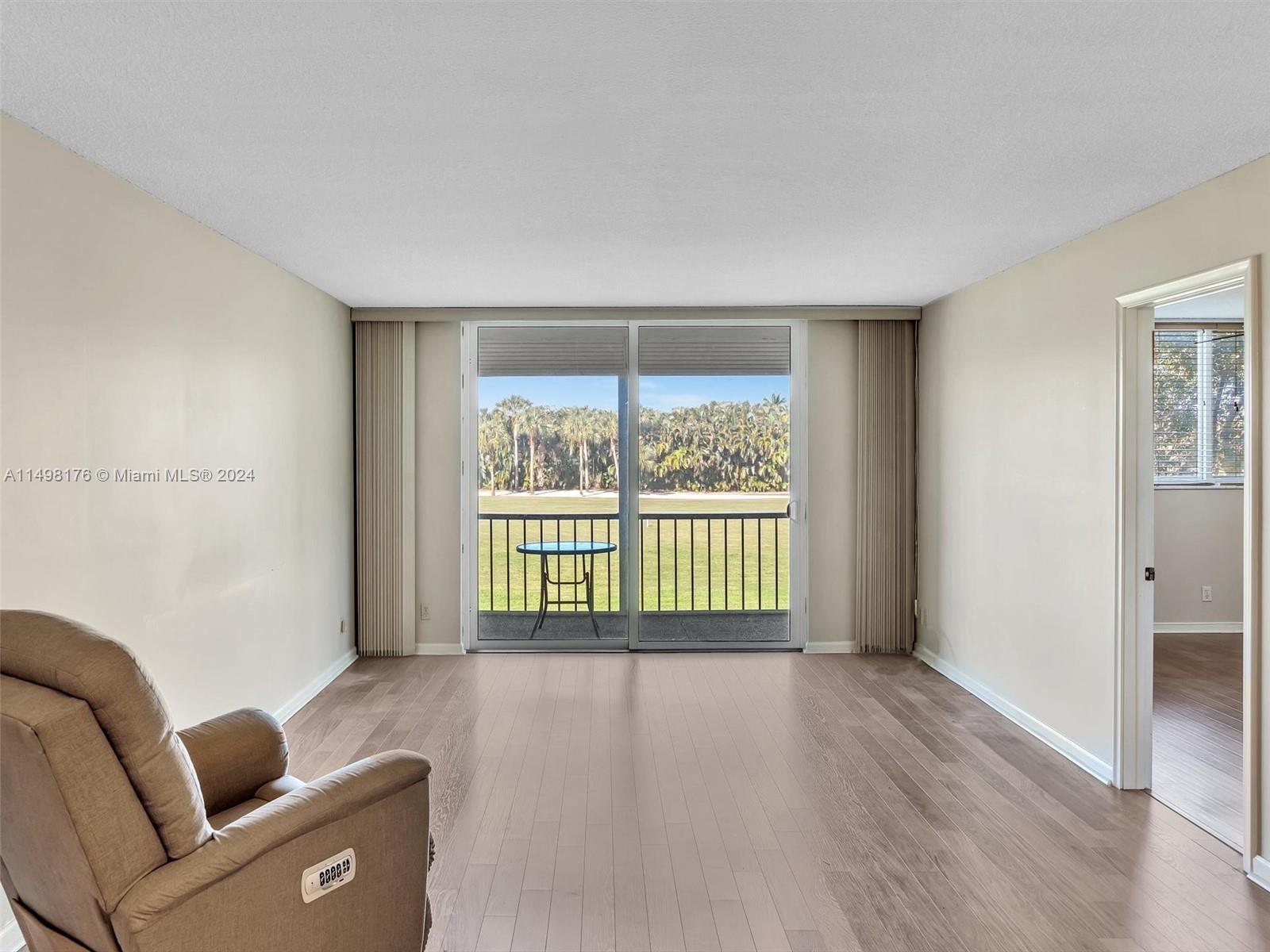 9411 North Hollybrook Lake Drive, Unit 209 Pembroke Pines, FL 33025 - Photo 12 of 36 a living room with furniture and a window