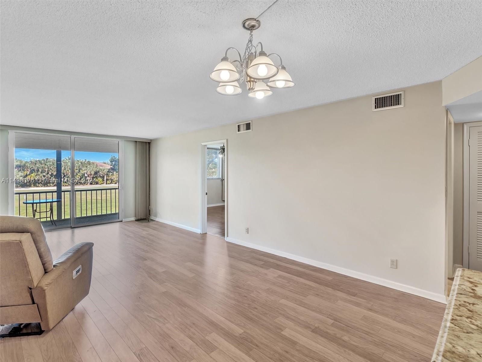 9411 North Hollybrook Lake Drive, Unit 209 Pembroke Pines, FL 33025 - Photo 13 of 36 a view of livingroom with furniture wooden floor and window