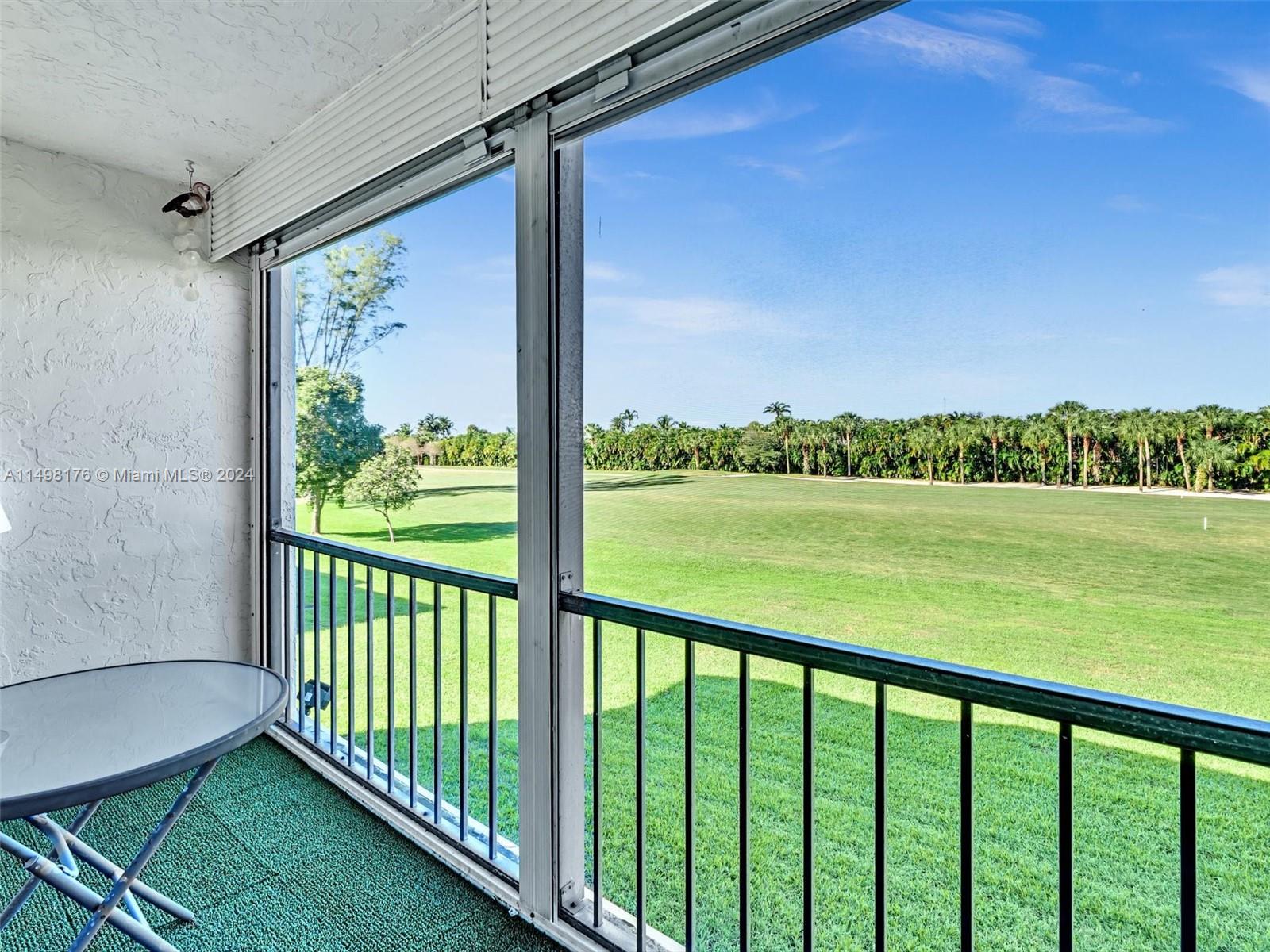 9411 North Hollybrook Lake Drive, Unit 209 Pembroke Pines, FL 33025 - Photo 2 of 36 a view of a deck with a big yard