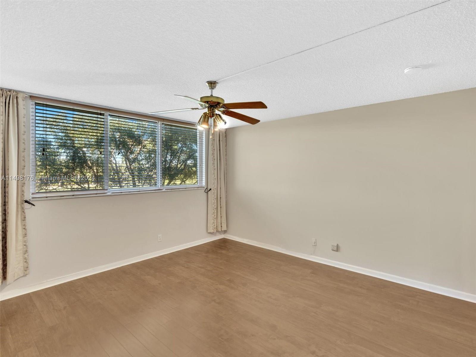 9411 North Hollybrook Lake Drive, Unit 209 Pembroke Pines, FL 33025 - Photo 23 of 36 an empty room with a window