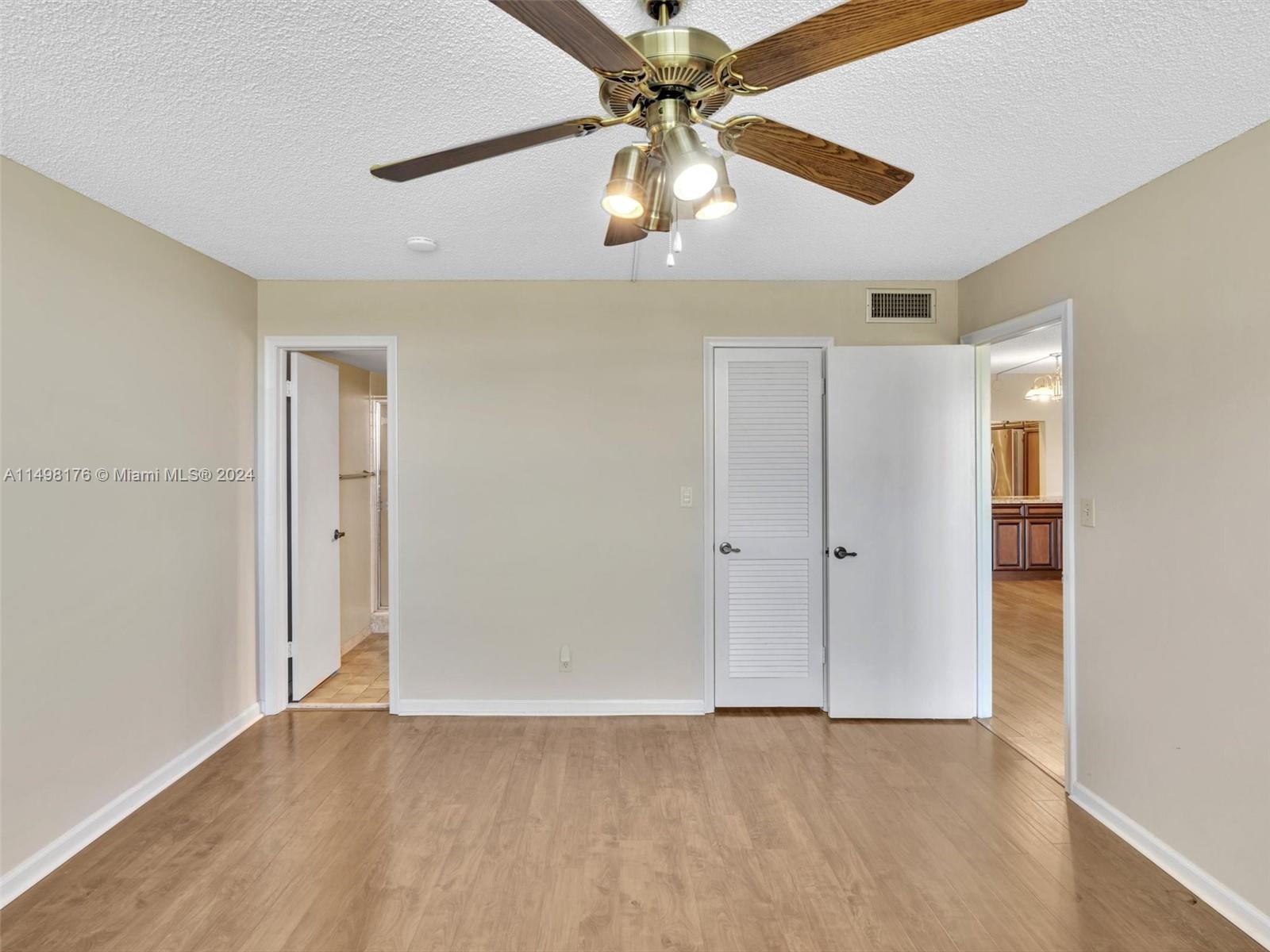 9411 North Hollybrook Lake Drive, Unit 209 Pembroke Pines, FL 33025 - Photo 25 of 36 an empty room with fan and a ceiling fan