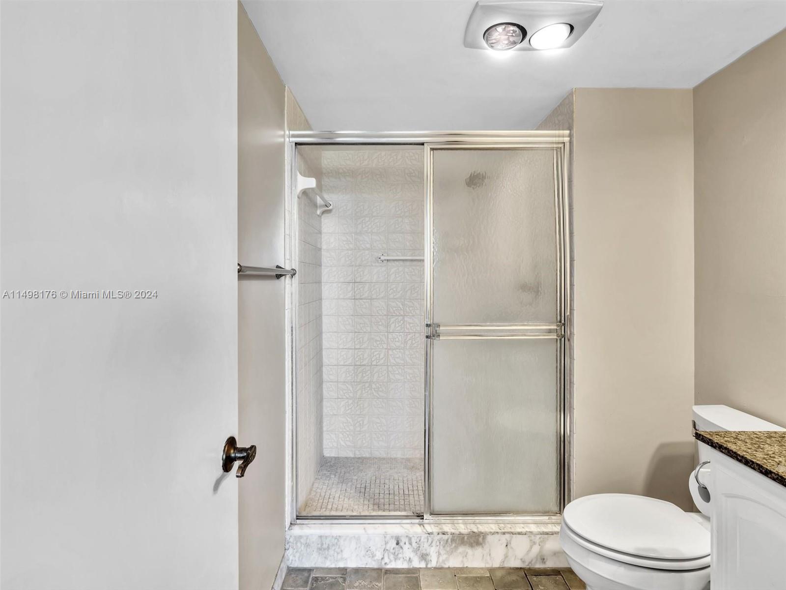 9411 North Hollybrook Lake Drive, Unit 209 Pembroke Pines, FL 33025 - Photo 27 of 36 a bathroom with a glass shower door