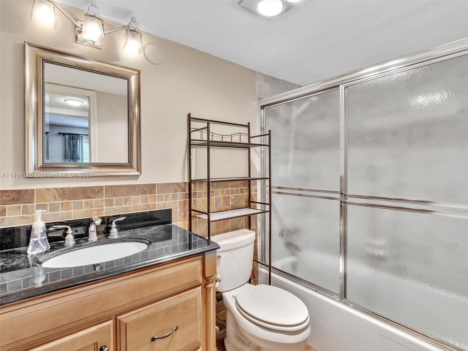 9411 North Hollybrook Lake Drive, Unit 209 Pembroke Pines, FL 33025 - Photo 33 of 36 a bathroom with a sink a toilet and shower