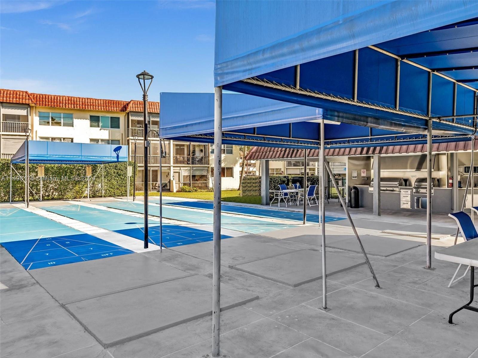 9411 North Hollybrook Lake Drive, Unit 209 Pembroke Pines, FL 33025 - Photo 34 of 36 a view of a patio with a table and chairs