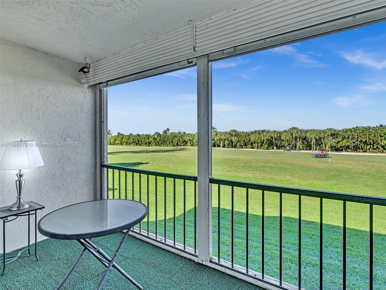 9411 North Hollybrook Lake Drive, Unit 209 Pembroke Pines, FL 33025 - Photo 36 of 36 a view of a balcony with furniture and a yard