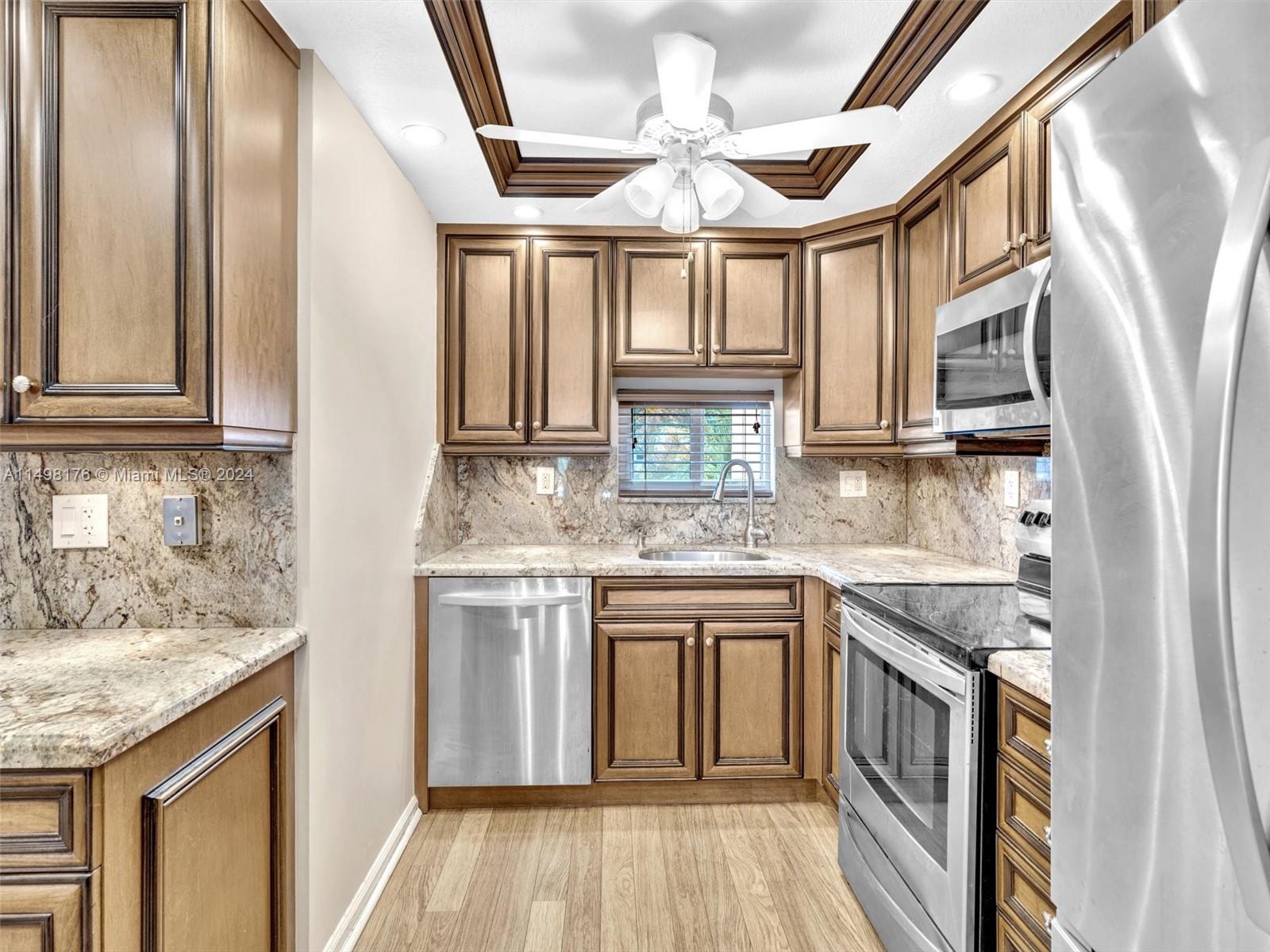 9411 North Hollybrook Lake Drive, Unit 209 Pembroke Pines, FL 33025 - Photo 5 of 36 a kitchen with stainless steel appliances granite countertop a stove and a sink