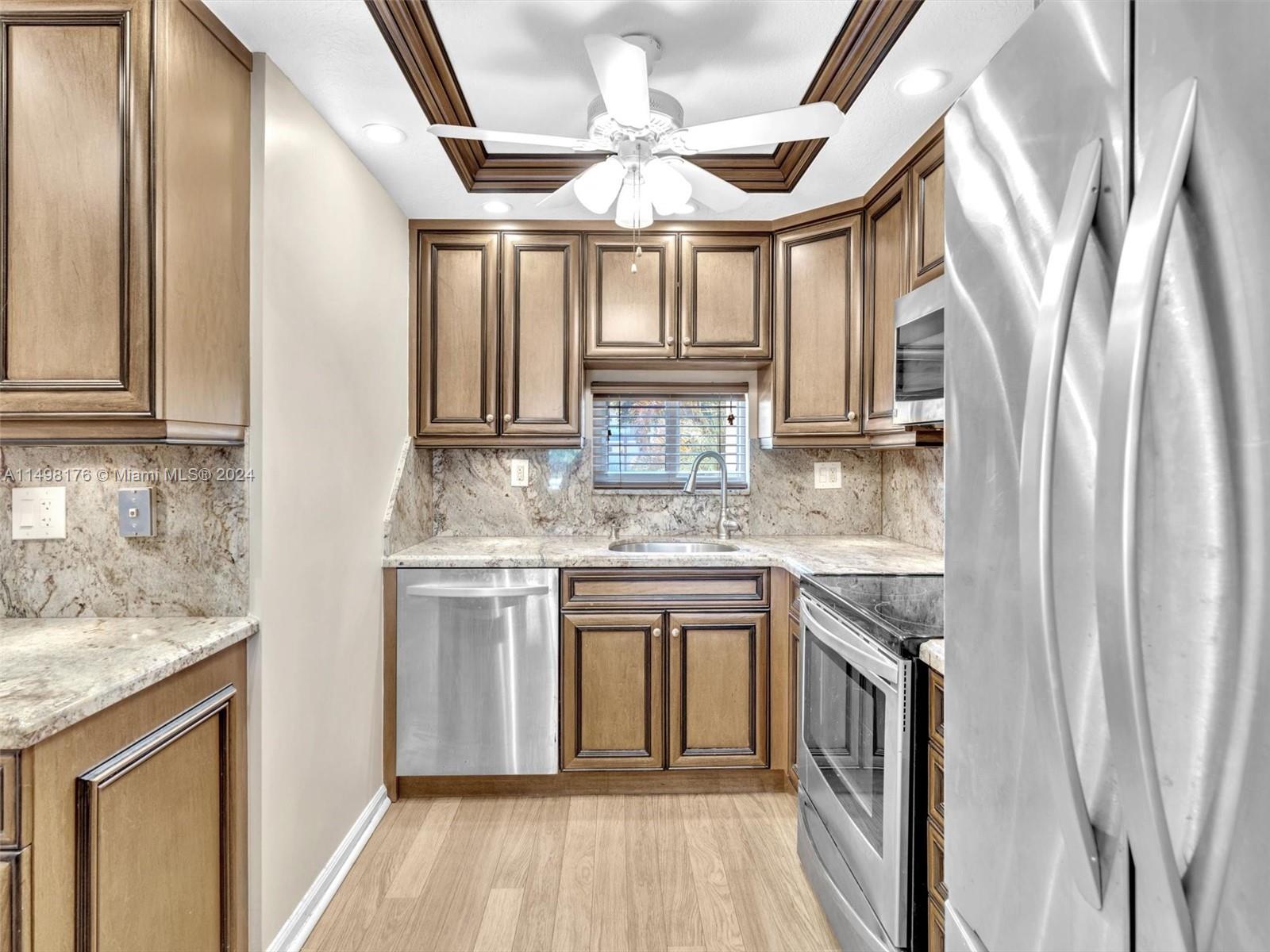 9411 North Hollybrook Lake Drive, Unit 209 Pembroke Pines, FL 33025 - Photo 6 of 36 a kitchen with stainless steel appliances granite countertop a stove and a sink