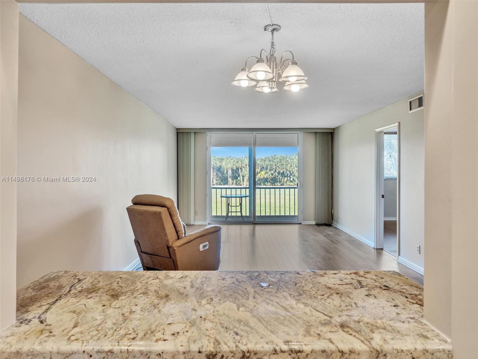 9411 North Hollybrook Lake Drive, Unit 209 Pembroke Pines, FL 33025 - Photo 9 of 36 a view of a bedroom with a bed and wooden floor
