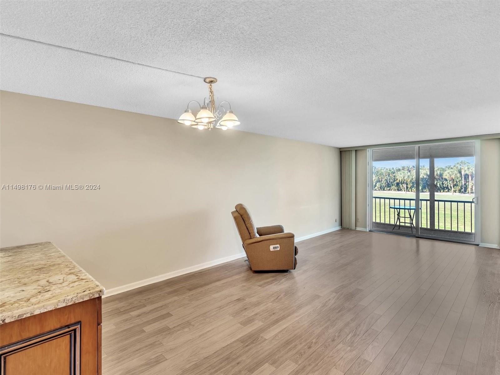 9411 North Hollybrook Lake Drive, Unit 209 Pembroke Pines, FL 33025 - Photo 10 of 36 a view of empty room with wooden floor and fan