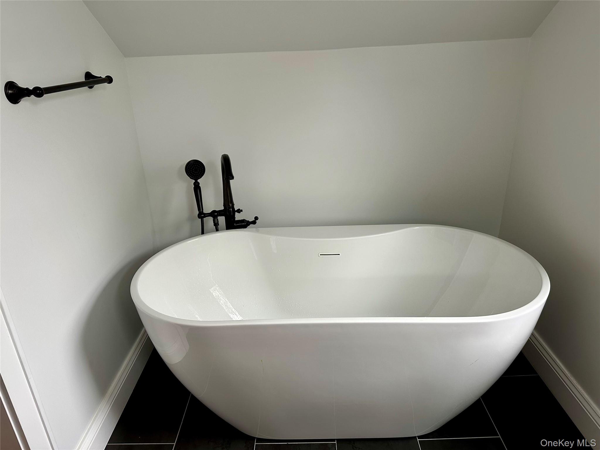 19 Ocean Road Ocean Beach, NY 11770 - Photo 13 of 20 Bathroom with tile patterned floors, baseboards, and a freestanding bath