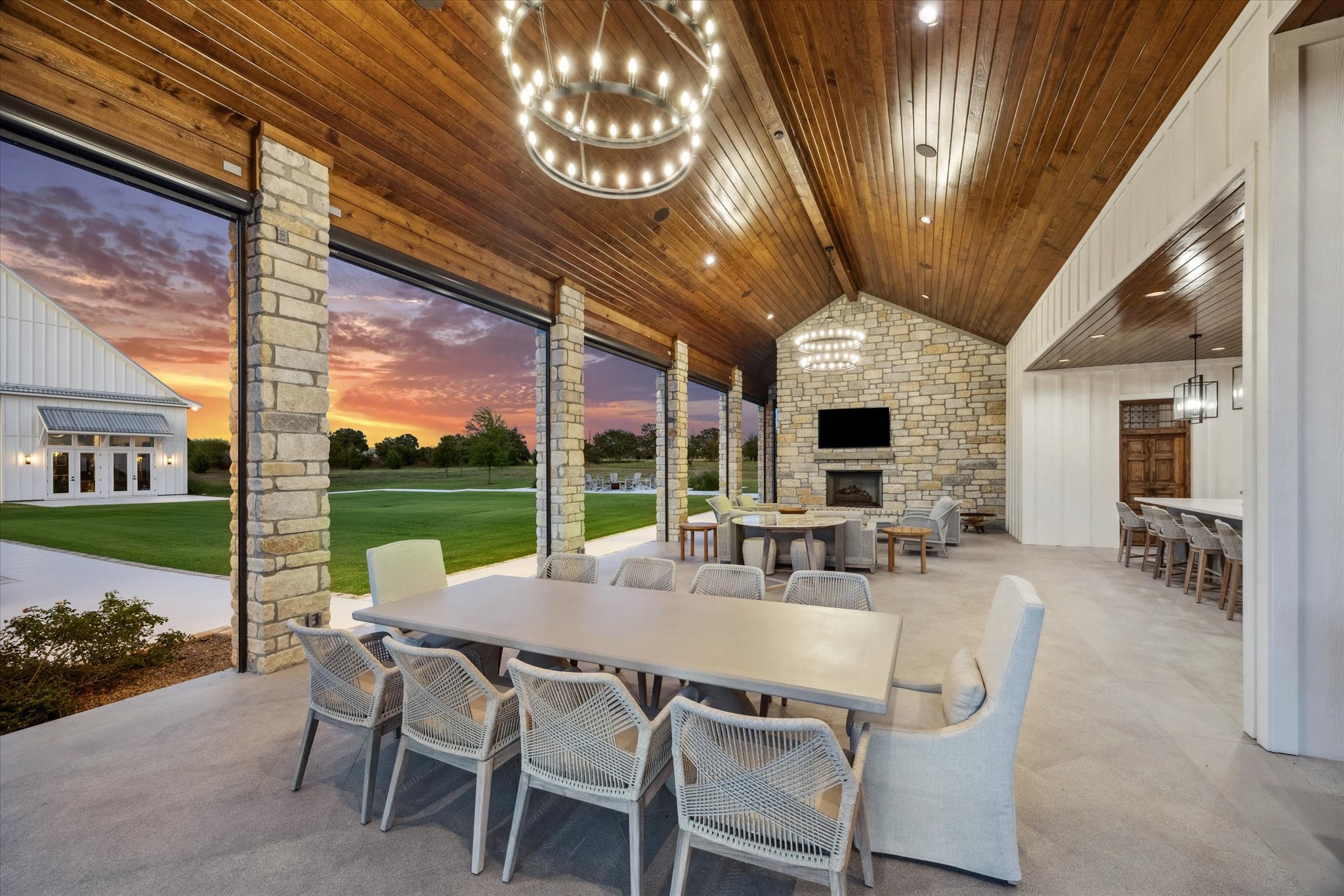 8611 Halamicek Loop Fayetteville, TX 78940 - Photo 28 of 41 a view of a patio with a dining table and chairs with a fireplace