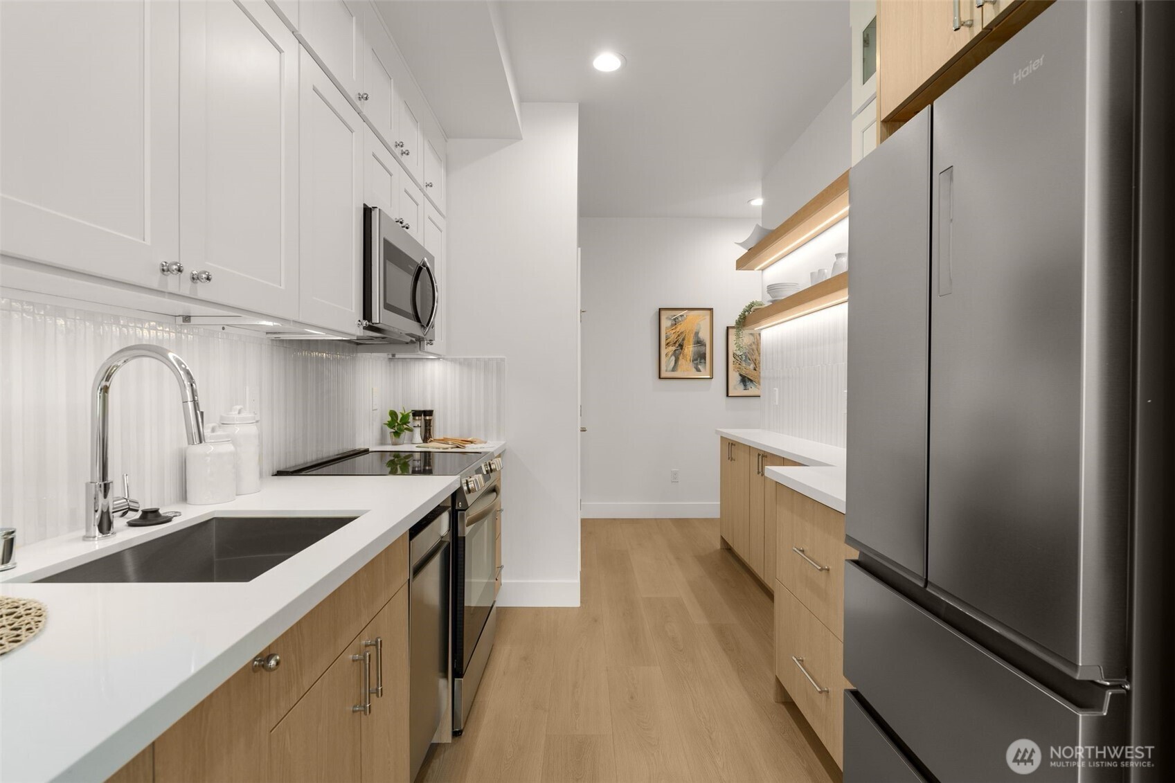 6247 Airport Way South, Unit A Seattle, WA 98108 - Photo 5 of 8 a kitchen with stainless steel appliances granite countertop a sink stove and refrigerator