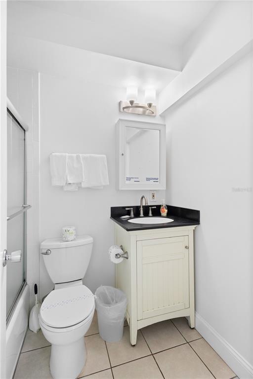 5830 Midnight Pass Road, Unit T22 Sarasota, FL 34242 - Photo 12 of 65 a bathroom with a sink toilet and a mirror