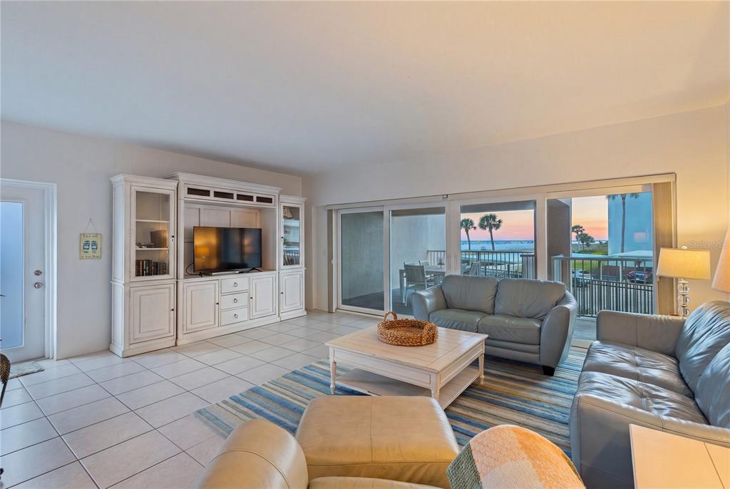 5830 Midnight Pass Road, Unit T22 Sarasota, FL 34242 - Photo 13 of 65 a living room with furniture and a flat screen tv