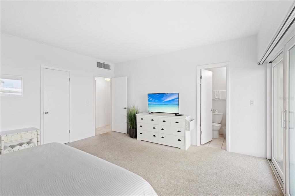 5830 Midnight Pass Road, Unit T22 Sarasota, FL 34242 - Photo 14 of 65 a bedroom with a bed and a dresser