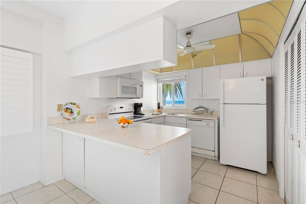 5830 Midnight Pass Road, Unit T22 Sarasota, FL 34242 - Photo 18 of 65 a kitchen with appliances a refrigerator and a sink