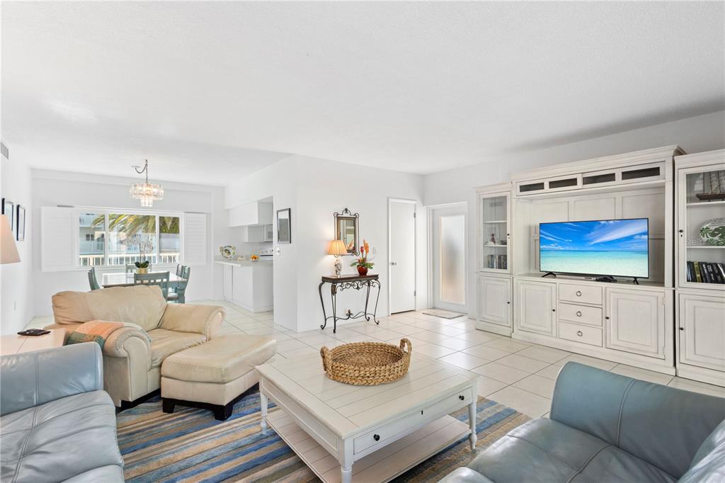 5830 Midnight Pass Road, Unit T22 Sarasota, FL 34242 - Photo 19 of 65 a living room with furniture and a flat screen tv