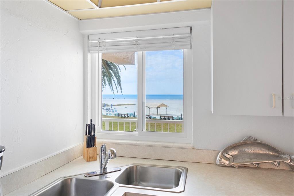 5830 Midnight Pass Road, Unit T22 Sarasota, FL 34242 - Photo 21 of 65 a kitchen with a sink and a window