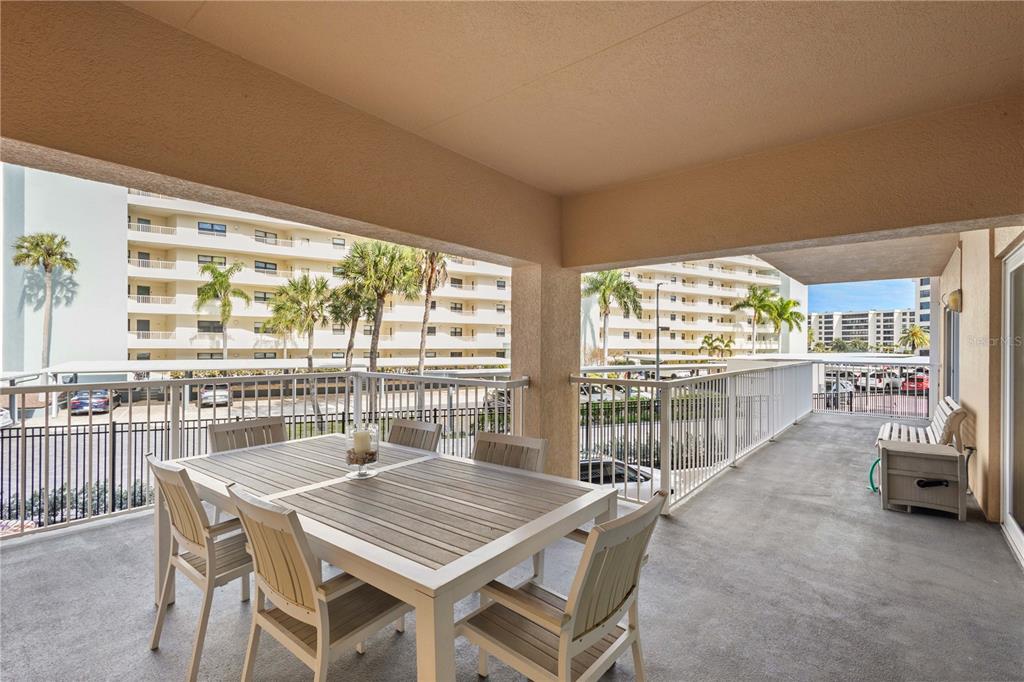 5830 Midnight Pass Road, Unit T22 Sarasota, FL 34242 - Photo 27 of 65 a dining room with furniture a chandelier and wooden floor